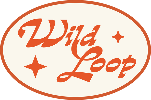 A circular logo with the text Wild Loop in stylized orange letters. Surrounding the text are three orange star shapes. The background is white with an orange border.